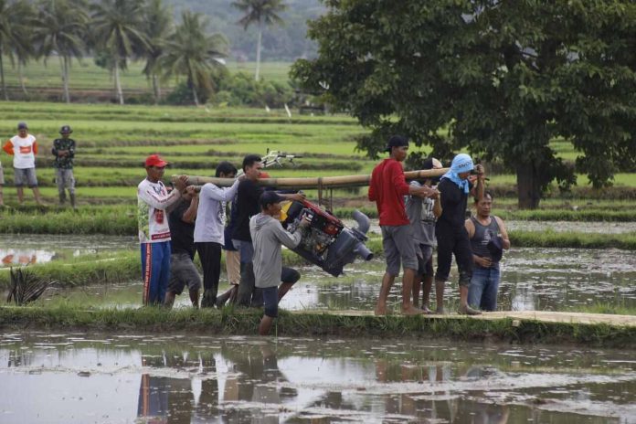 petani-pompa-air petani menggotong mesin pompa air